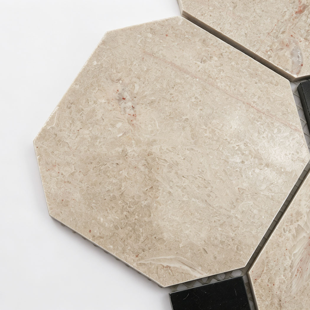 Close-up of a beige marble octagon mosaic tile with natural veining