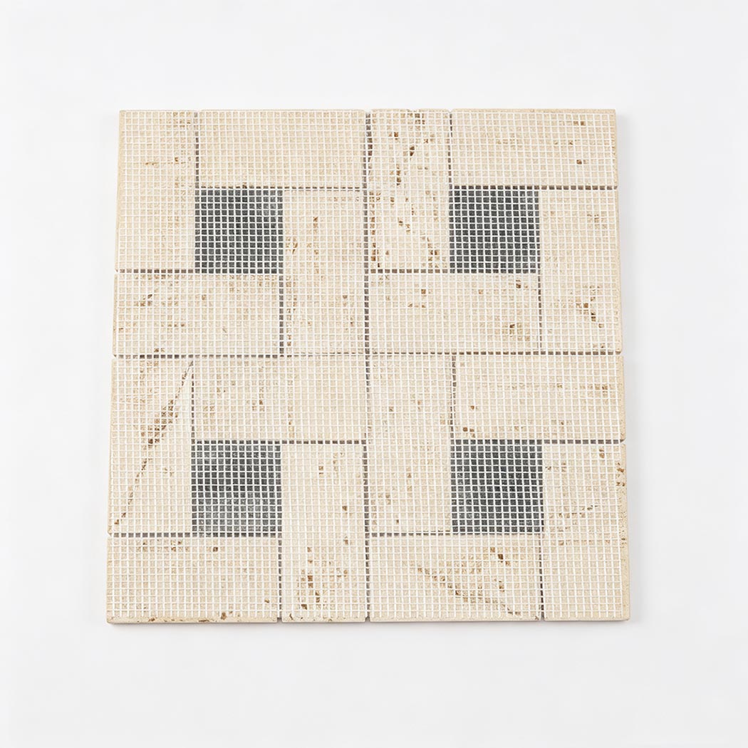 Mesh back view of beige travertine and black marble geometric mosaic tile