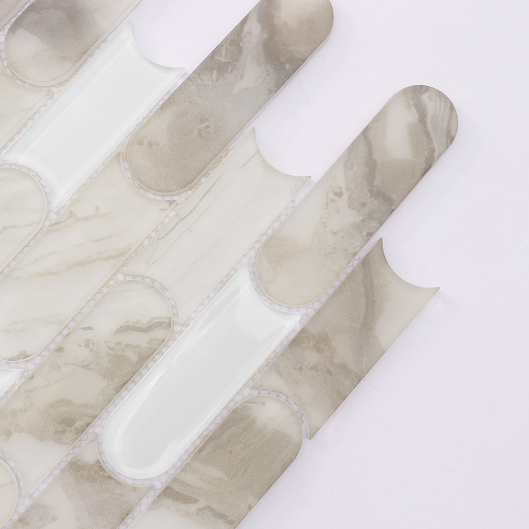 Close up of beige white interlocking capsule glass mosaic tile pieces