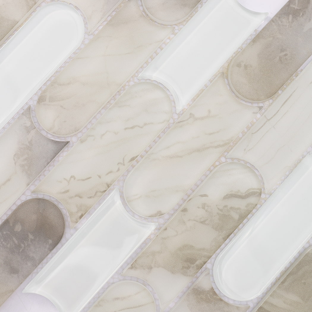 Beige patterned and white interlocking capsule glass mosaic tile surface detail