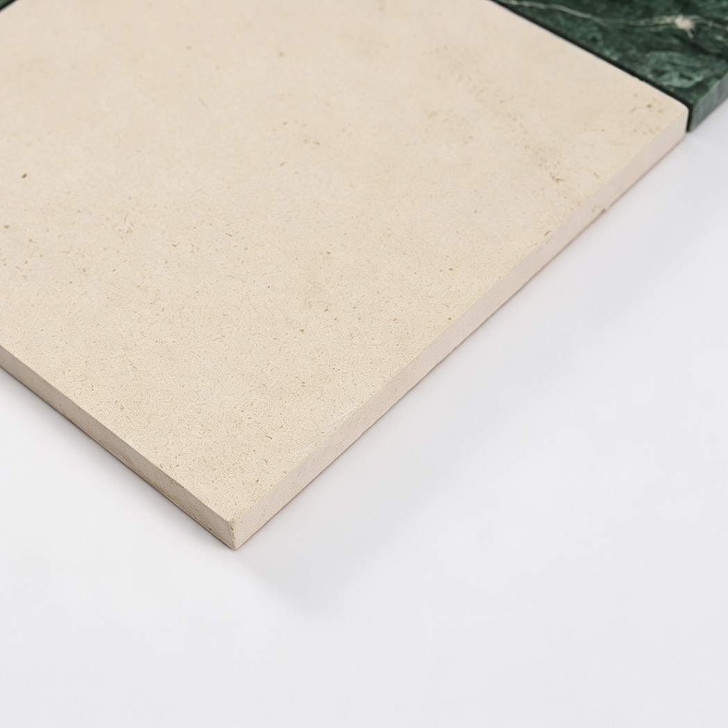 Beige marble close-up from dark green and beige checkered mosaic tile