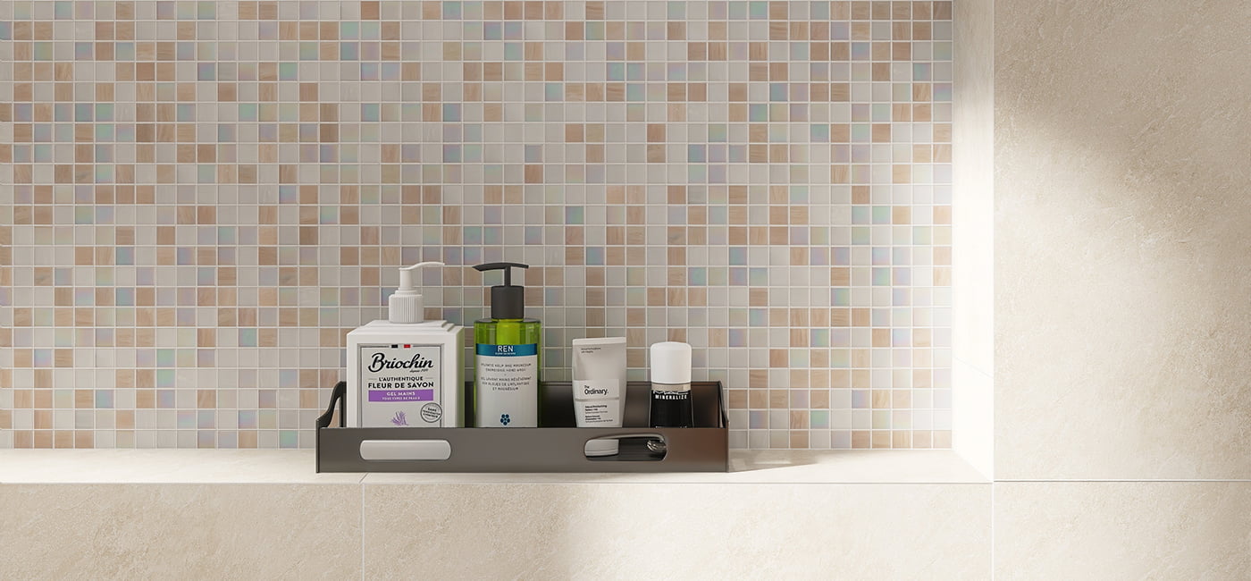 Beige and white mosaic tiles in the background with personal care items on a shelf