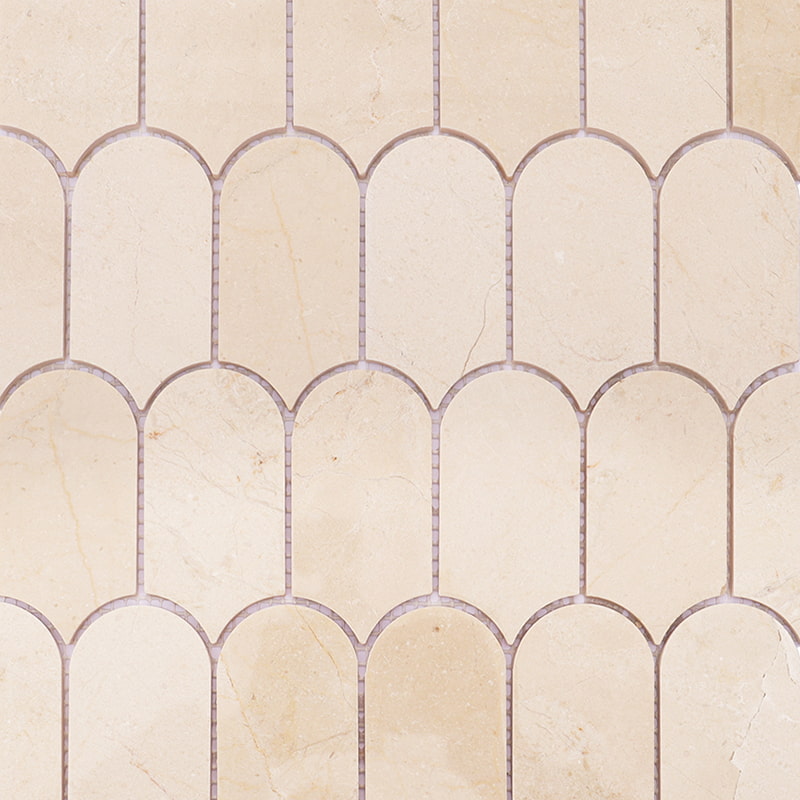 Beige arched marble mosaic tiles with soft veining in a traditional pattern.