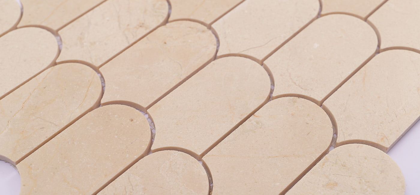 Beige long fish scale-shaped marble mosaic tiles with smooth surface.