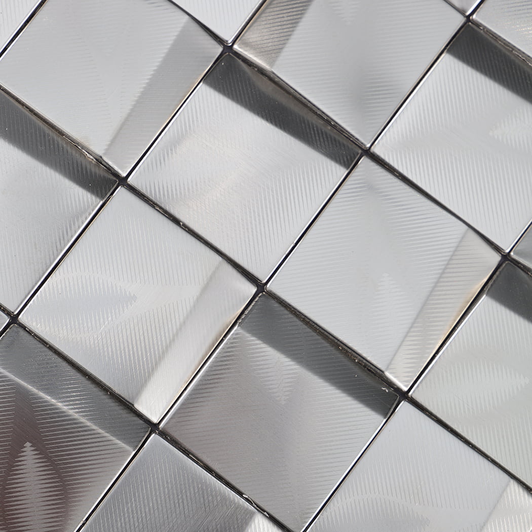 Diagonal close-up of beveled stainless steel square mosaic pattern with reflective texture.