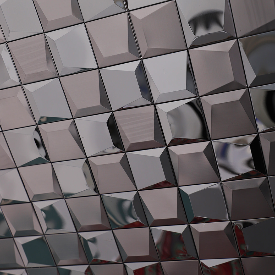 Close-up texture detail of black 3D stainless steel mosaic tiles.