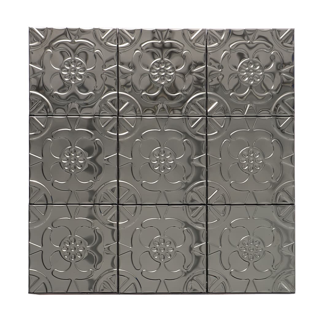Straight-on view of a glossy black embossed floral metal mosaic tile sheet.