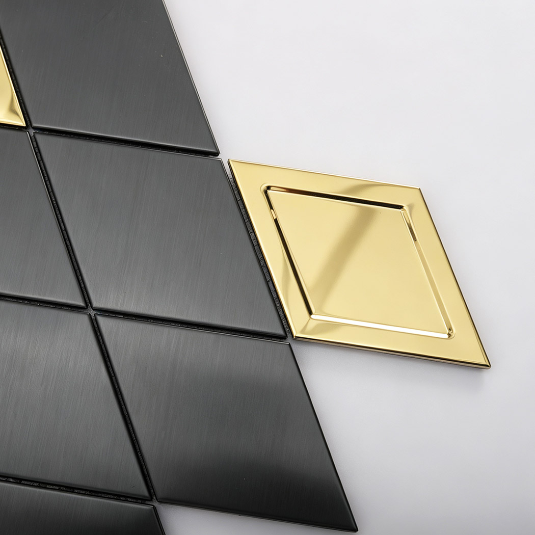 Close up of black brushed metal mosaic tiles with gold diamond accents