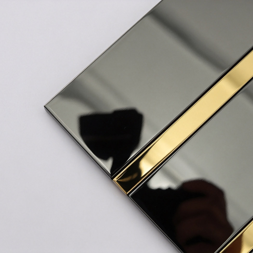 Corner close-up of black vertical stacked tile with gold metal inlay