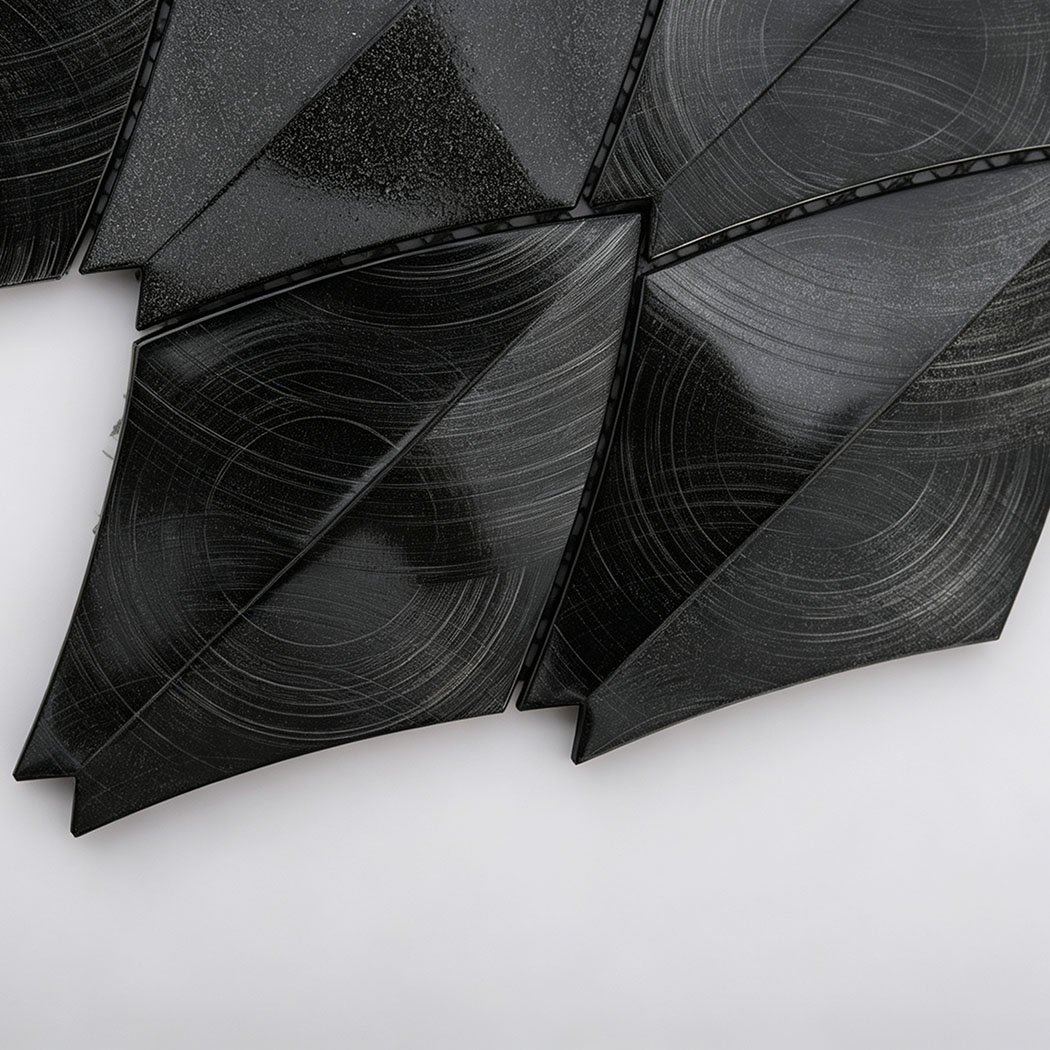 Close-up of black leaf aluminum mosaic tiles with brushed and glossy textures