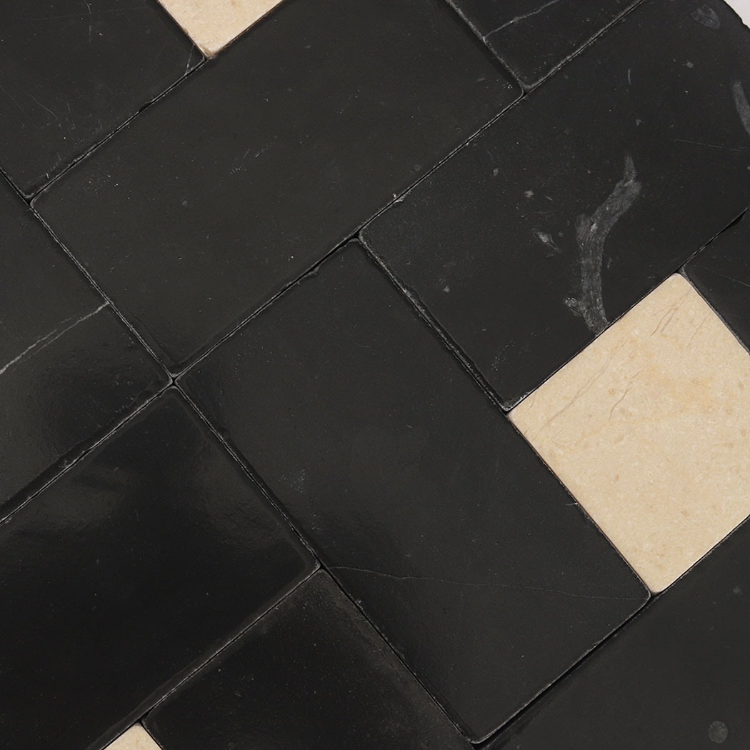 Interlocking black marble rectangles with natural veins and cream accents