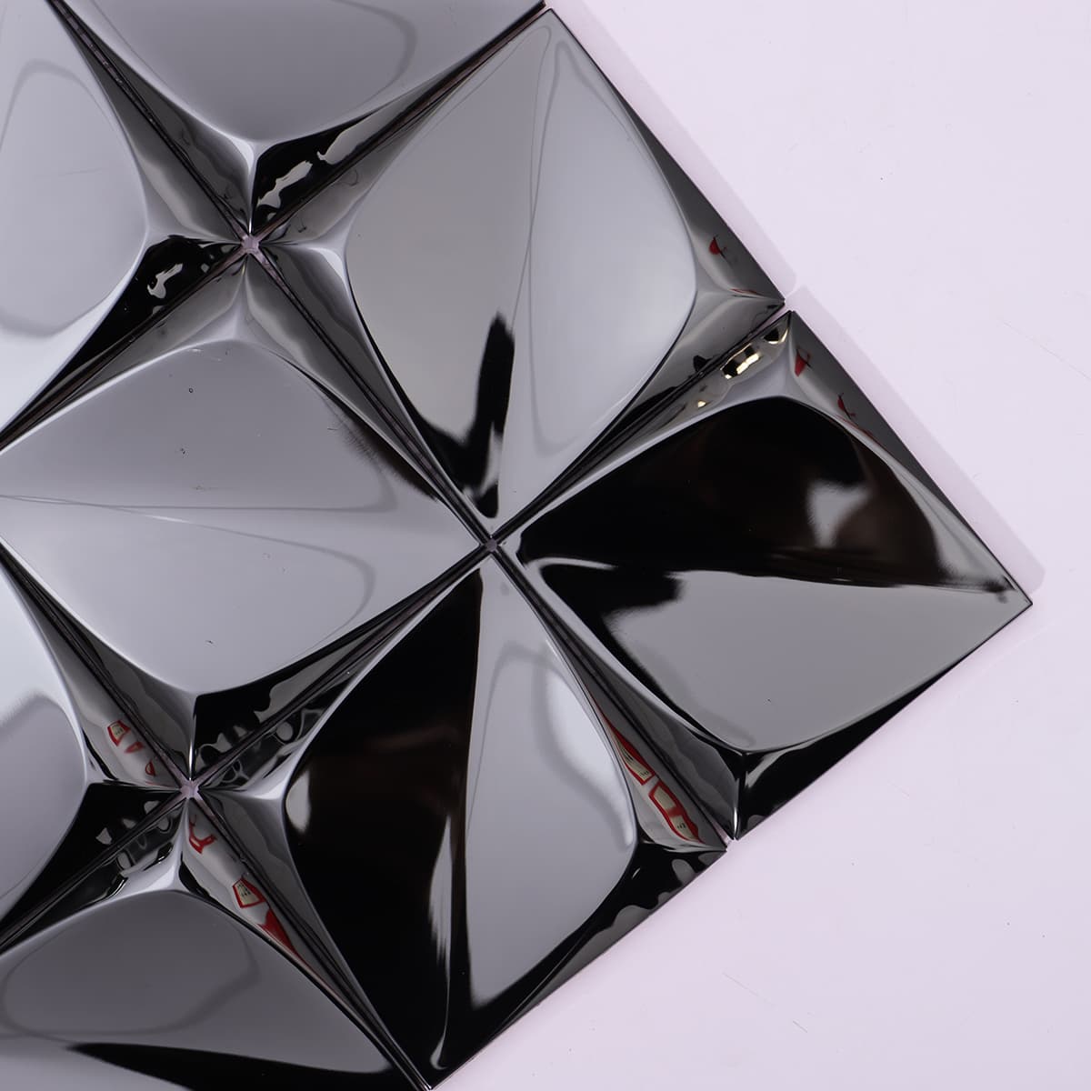 Close-up of black mirror stainless steel mosaic with 3D square pyramid design