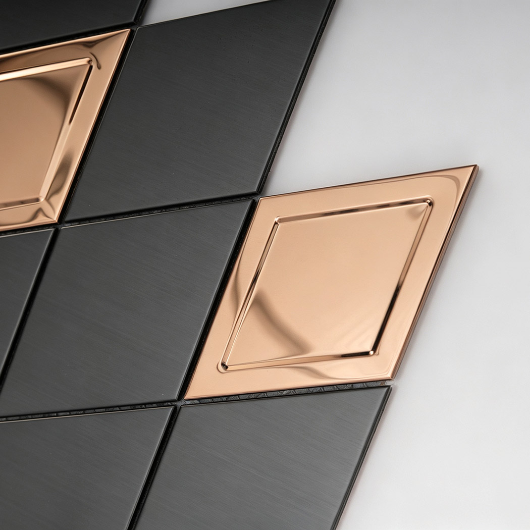 Close up of black brushed metal mosaic tiles with rose gold diamond accents