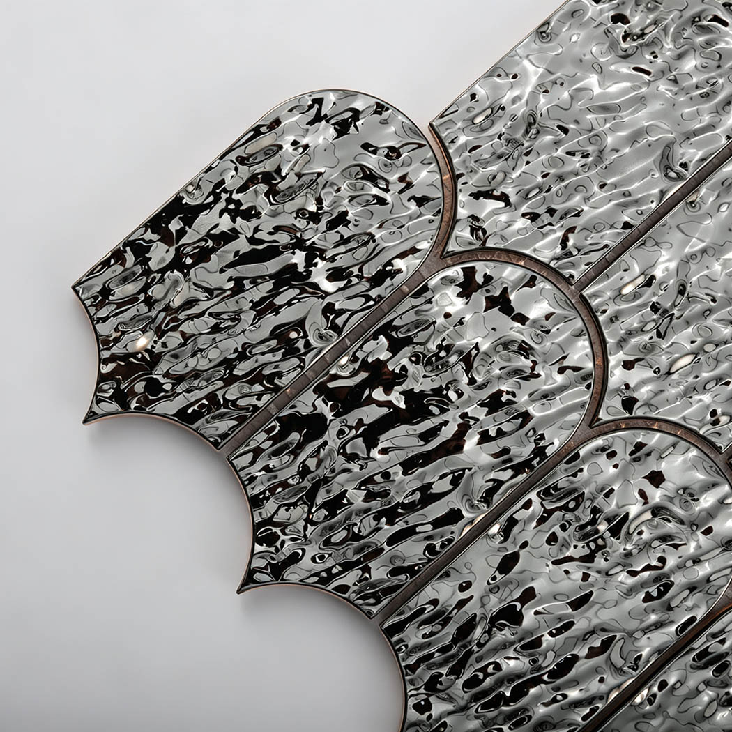 Close-up of black silver ripple metal fan mosaic tiles with a glossy finish