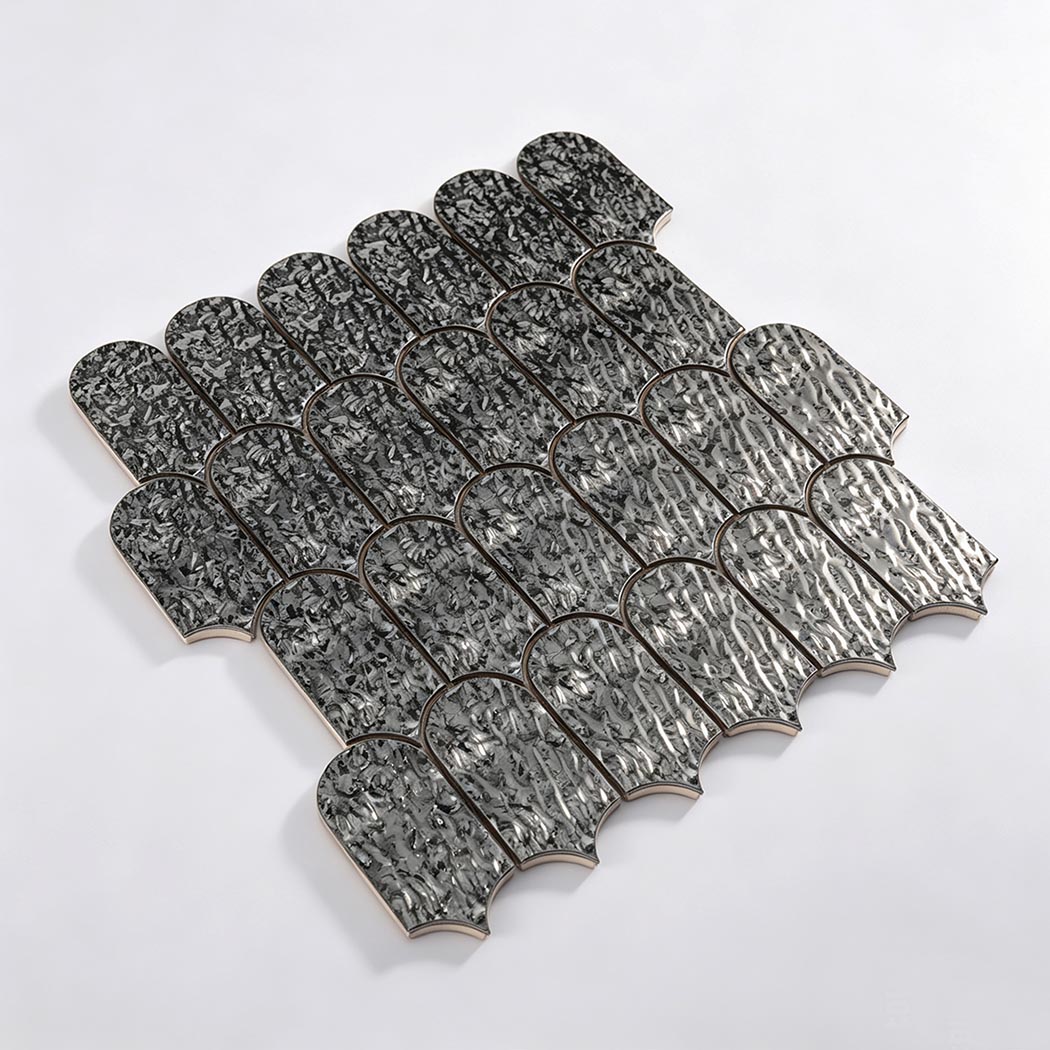 Angled view of black silver ripple fan metal mosaic tile sheet