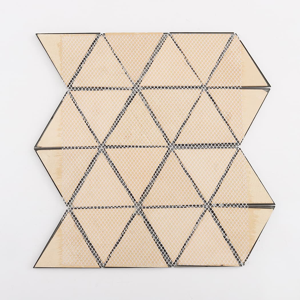 Back of a black triangle mosaic tile sheet showing the white mesh for easy installation.