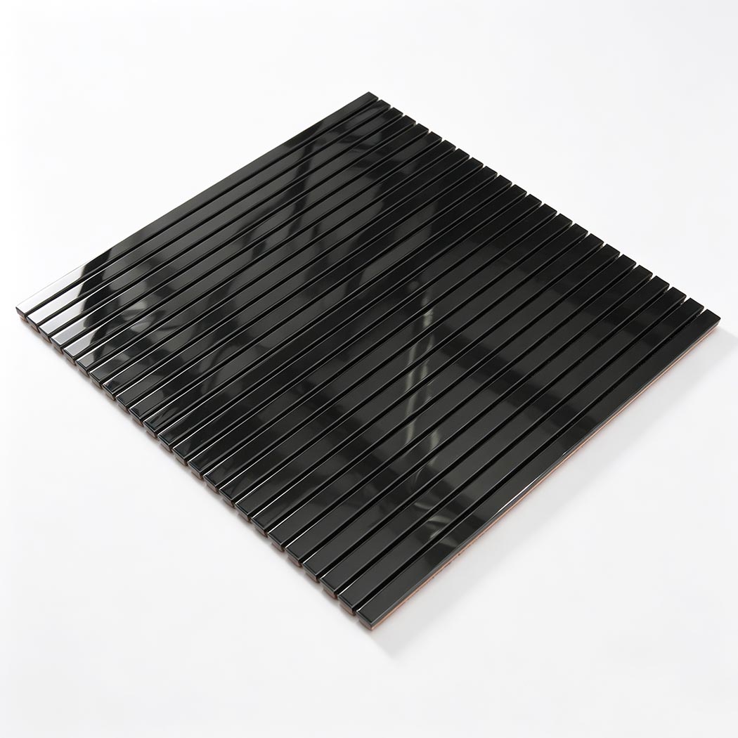 Angled view of black stainless steel pencil shower tile sheet