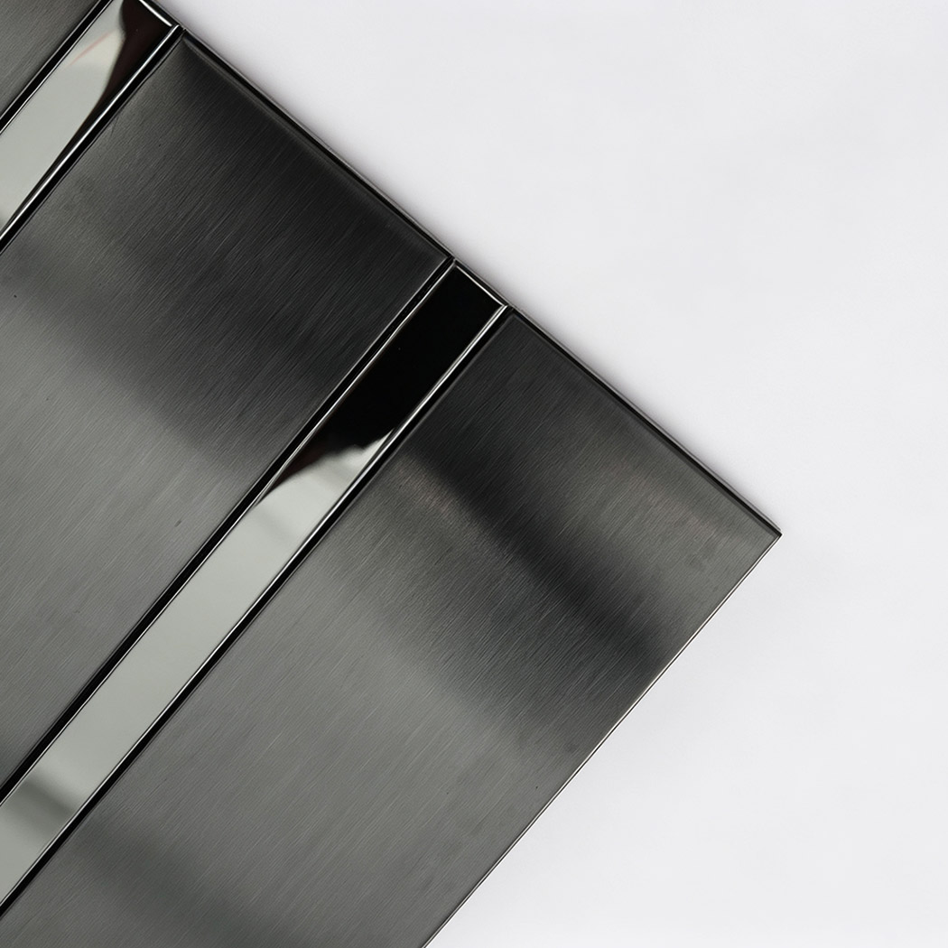 Angled close-up of black stainless steel striped tile strips