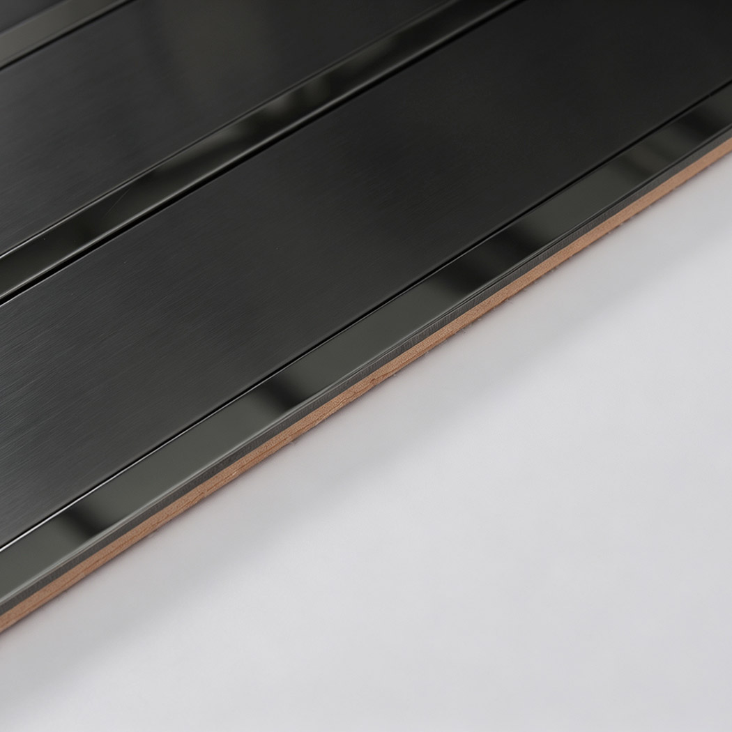 Side profile showing the layered construction of a black metal tile