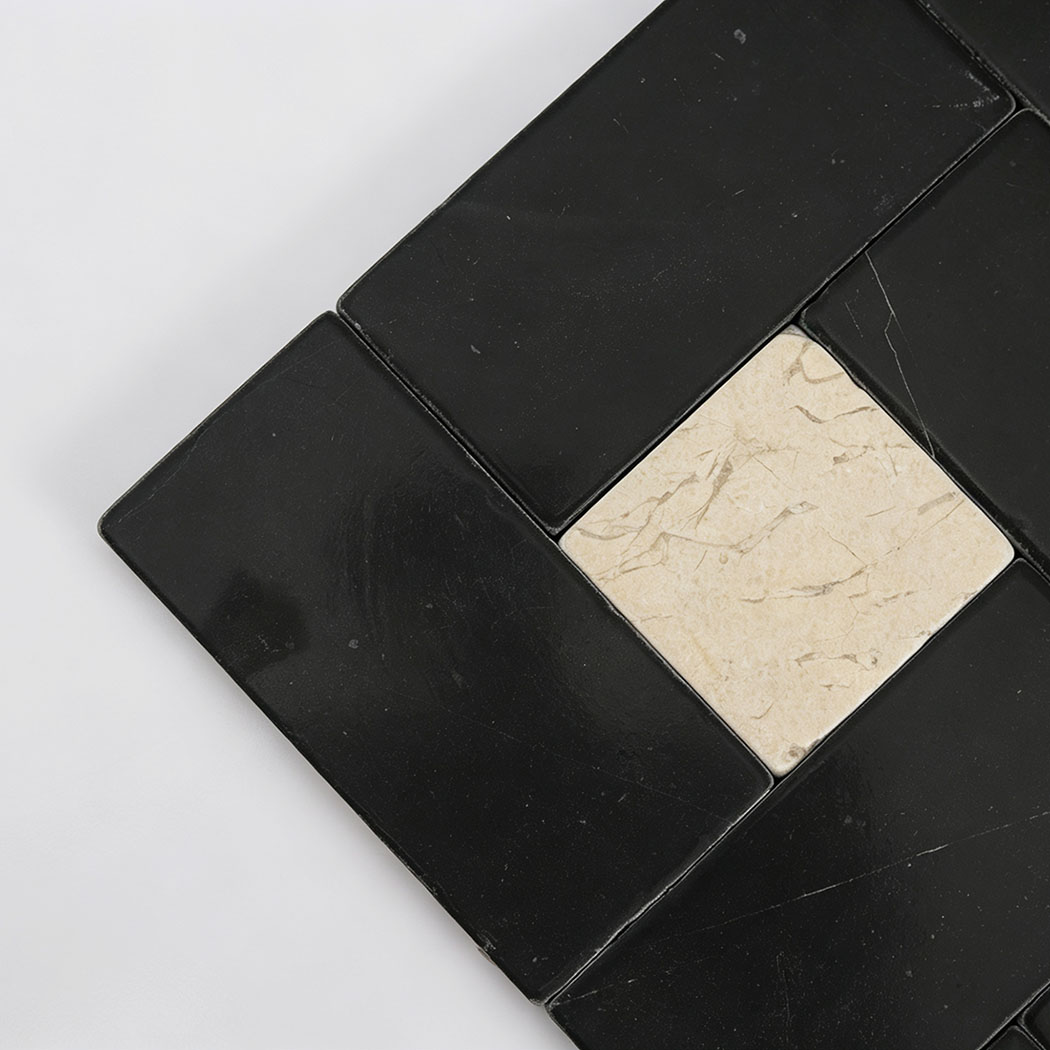 Cream marble square framed by interlocking black marble rectangles