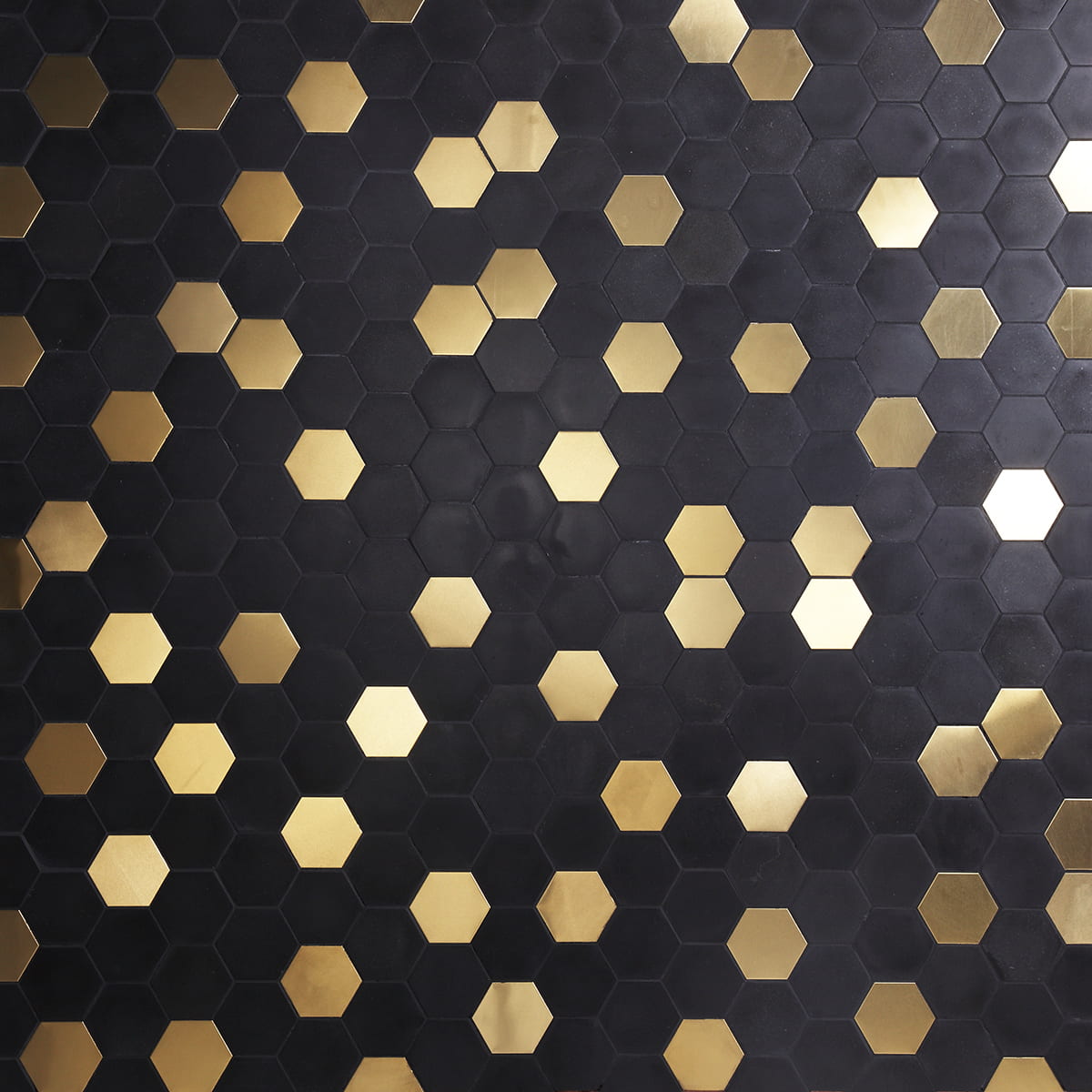 Black and gold hexagonal mosaic tiles forming a striking geometric pattern
