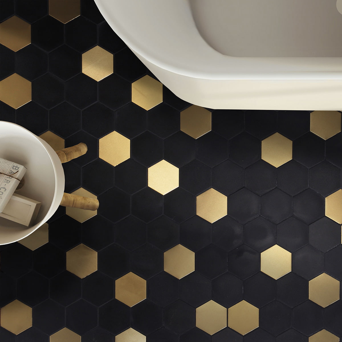 Black and gold hexagonal mosaic tiles on the floor with modern bathroom decor