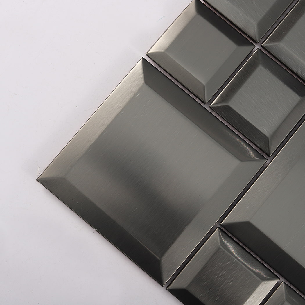 Close up of black brushed stainless steel tile showing beveled edges and metal texture
