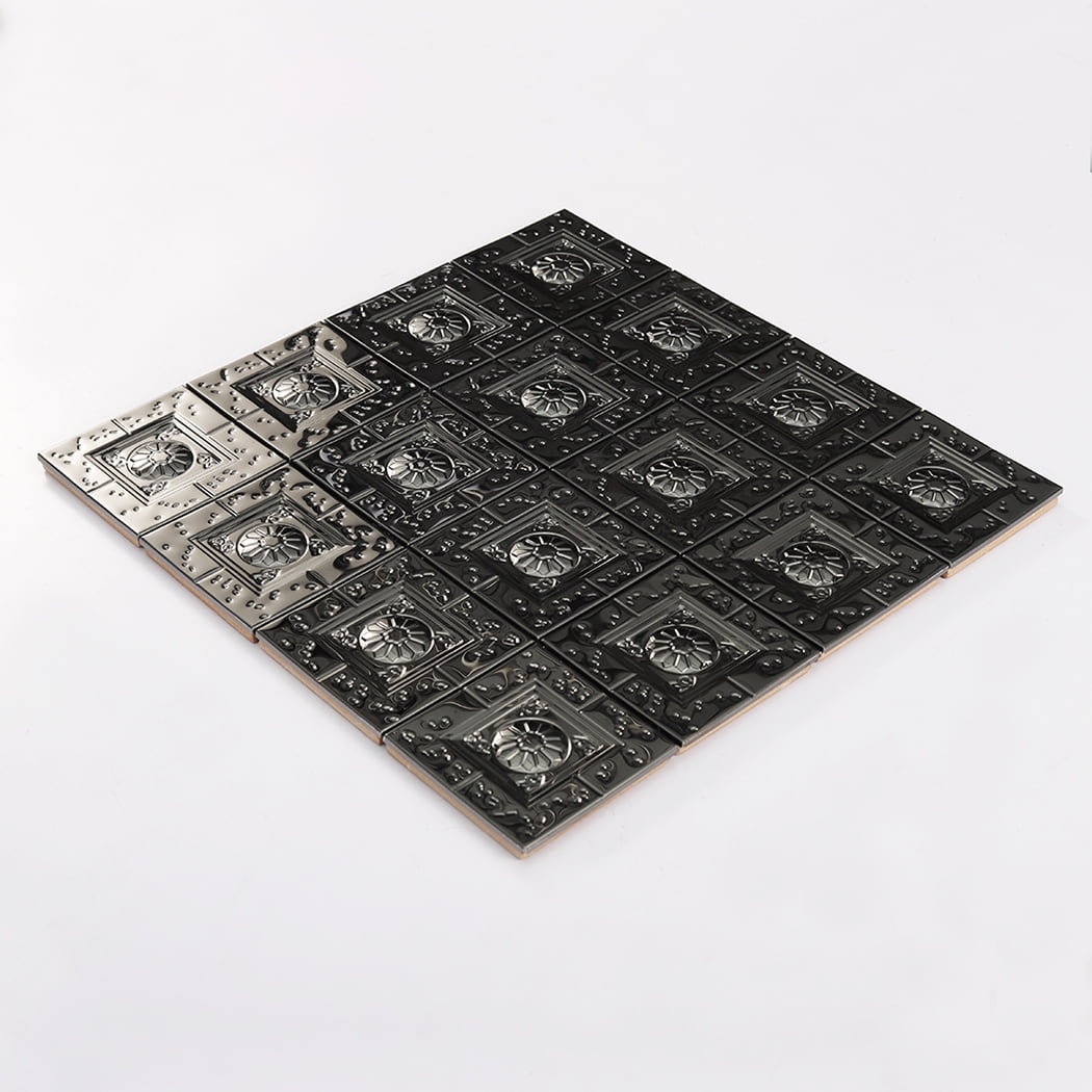 Full view of black embossed metal mosaic tile sheet on a white background