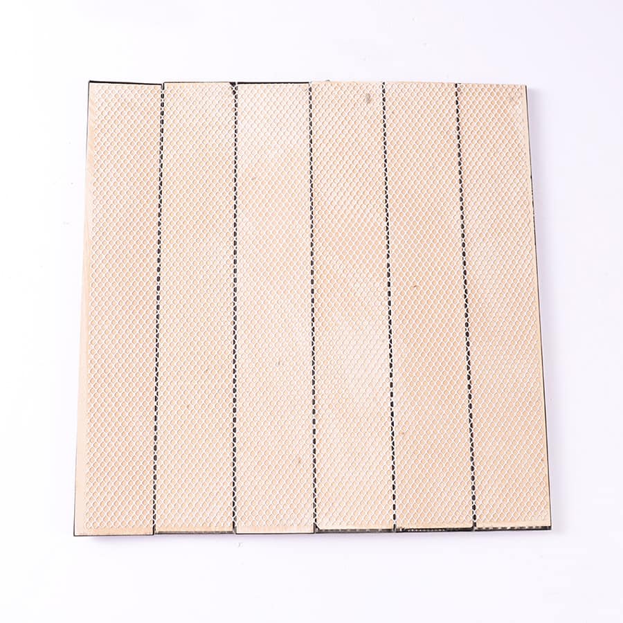 Back side of black metal mosaic tile showing beige mesh backing for installation.