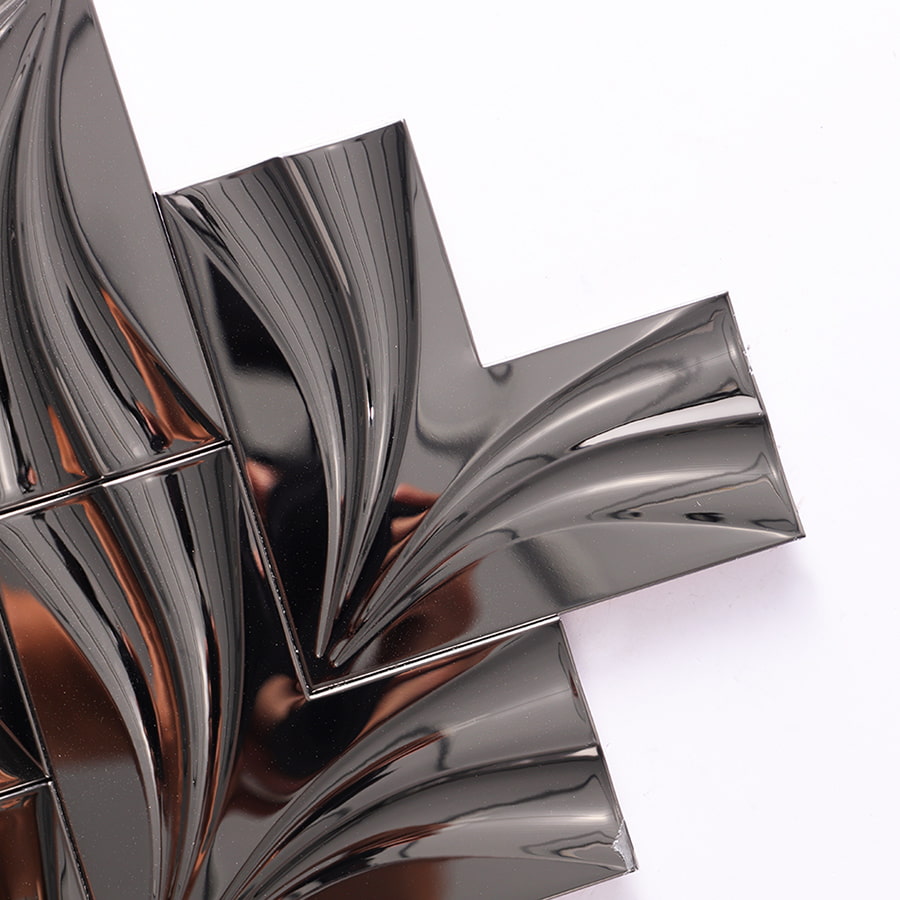 Close up of black mirror groutless herringbone metal mosaic tile corner