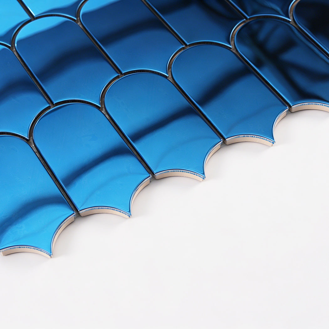 Side close up of blue arch metal mosaic tile showing thickness and rounded edges