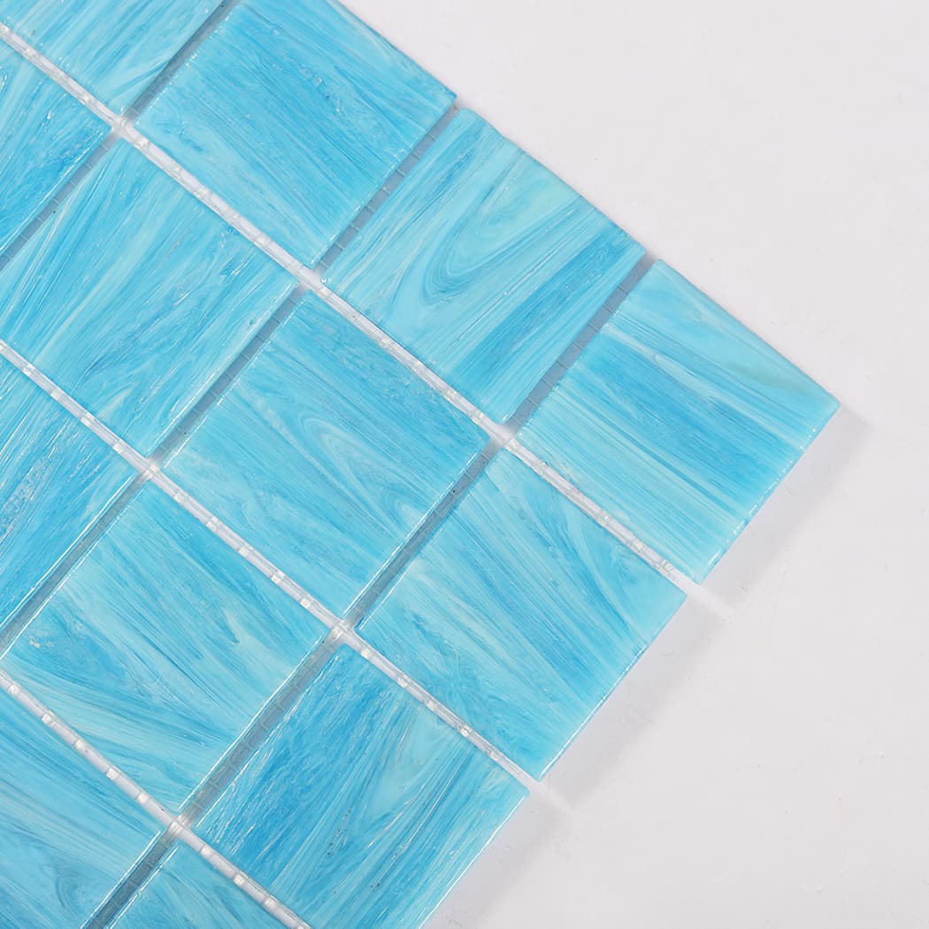 Close up of corner detail on blue glass mosaic tile sheet