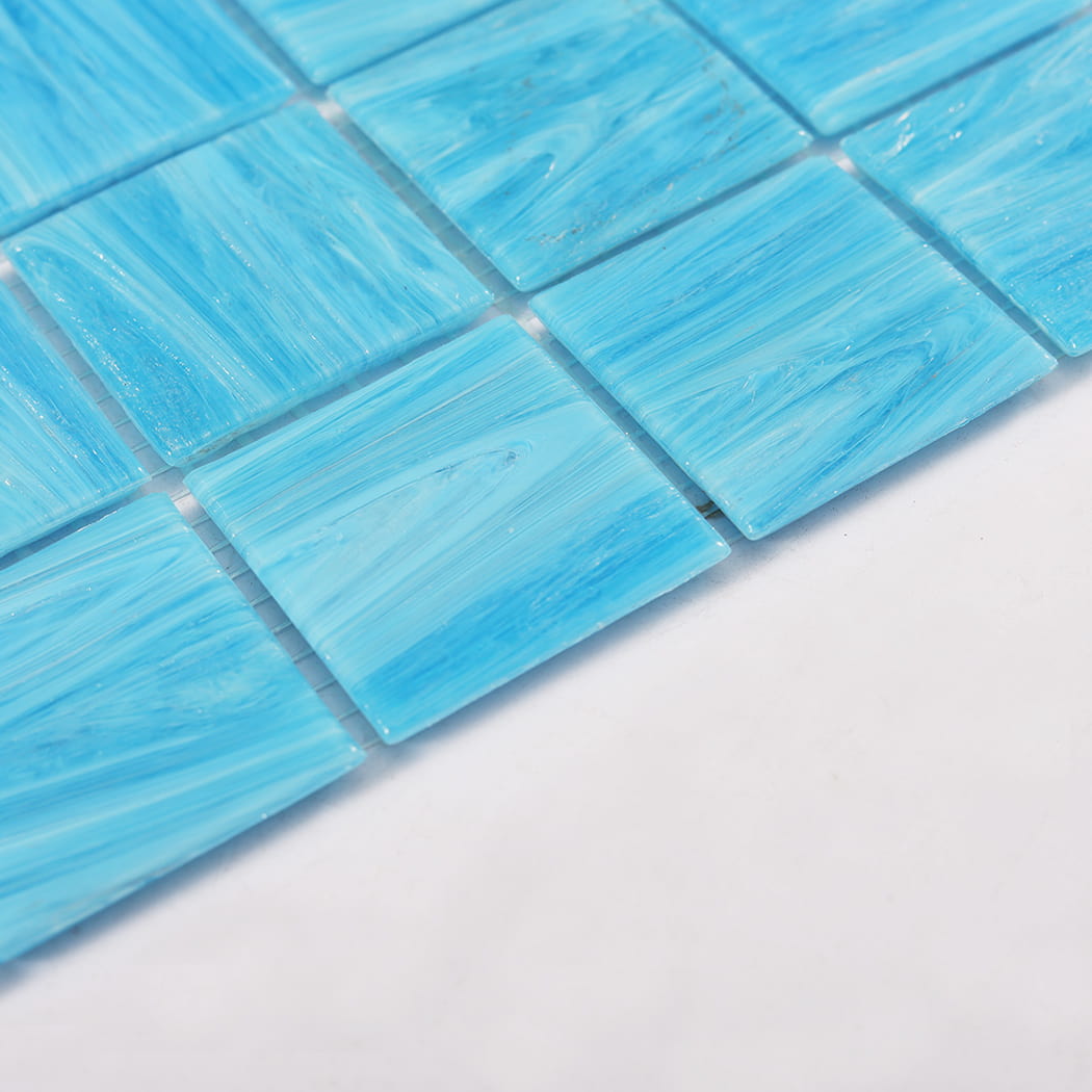 Close up of edge and surface texture on blue glass mosaic tiles