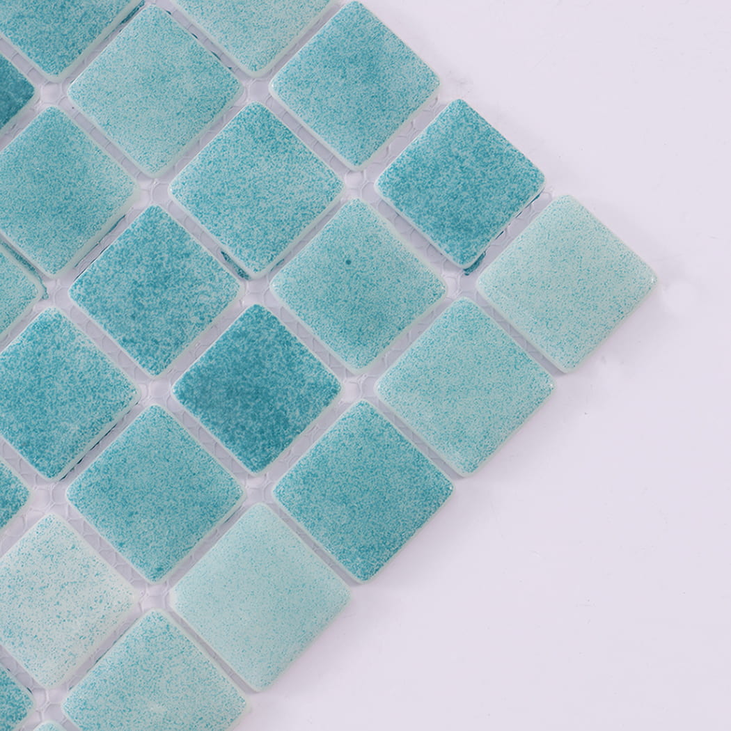 Close-up angled view showing the texture of blue green recycled glass tiles.