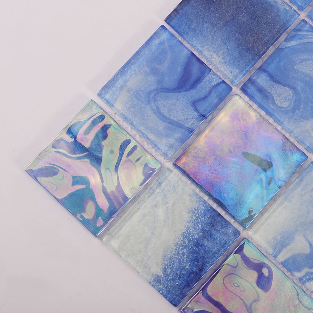 Close up of blue and iridescent square glass mosaic tiles with flowing patterns