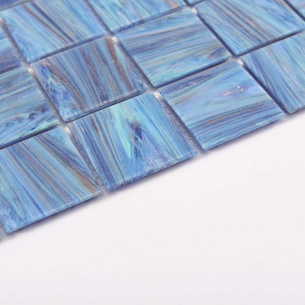 Angled closeup showing raised blue marble glass mosaic squares and grout gaps