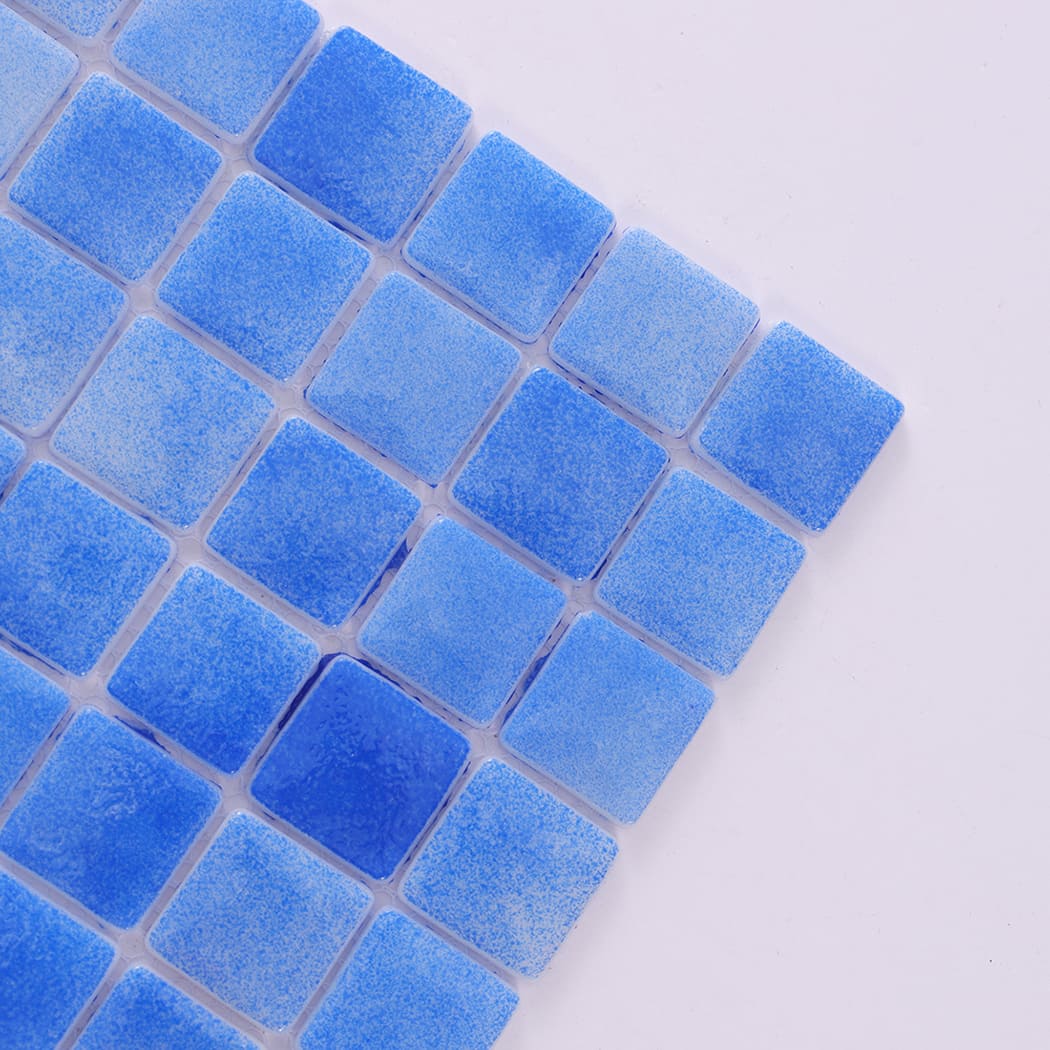 Angled close-up view showing texture of blue recycled glass mosaic tiles.