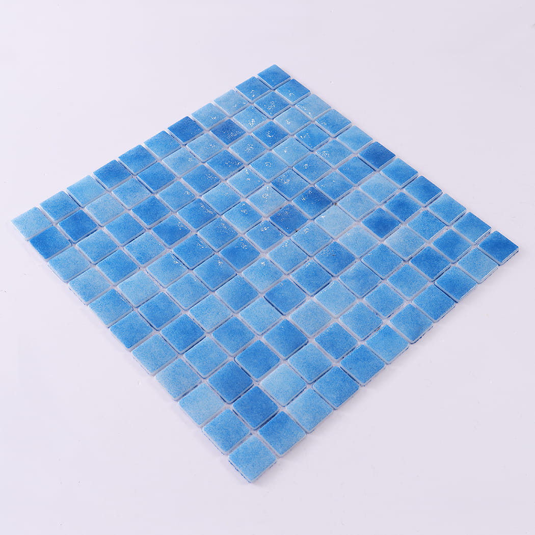 Angled view of blue recycled glass mosaic pool tile sheet