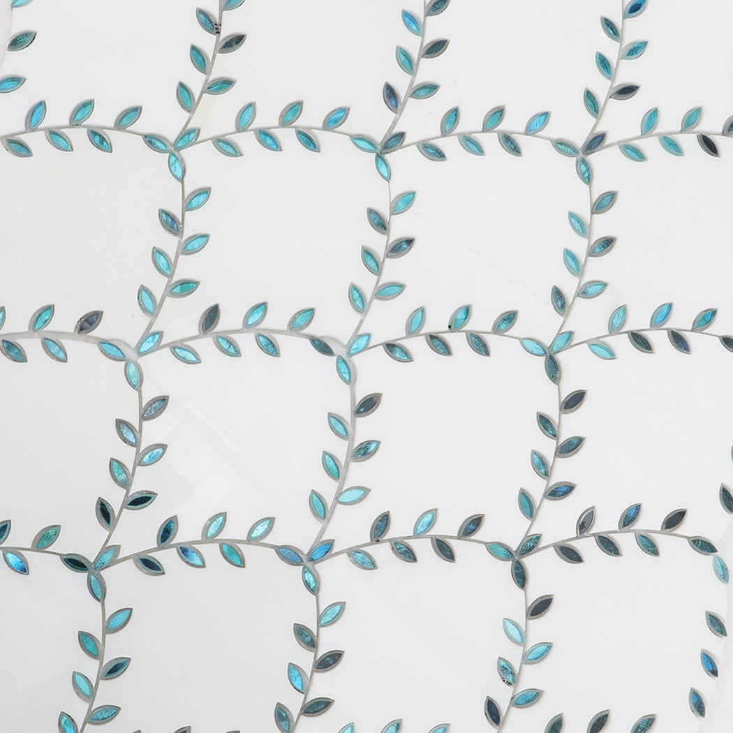 Mosaic layout showing repeated blue leaf patterns on white marble tiles.