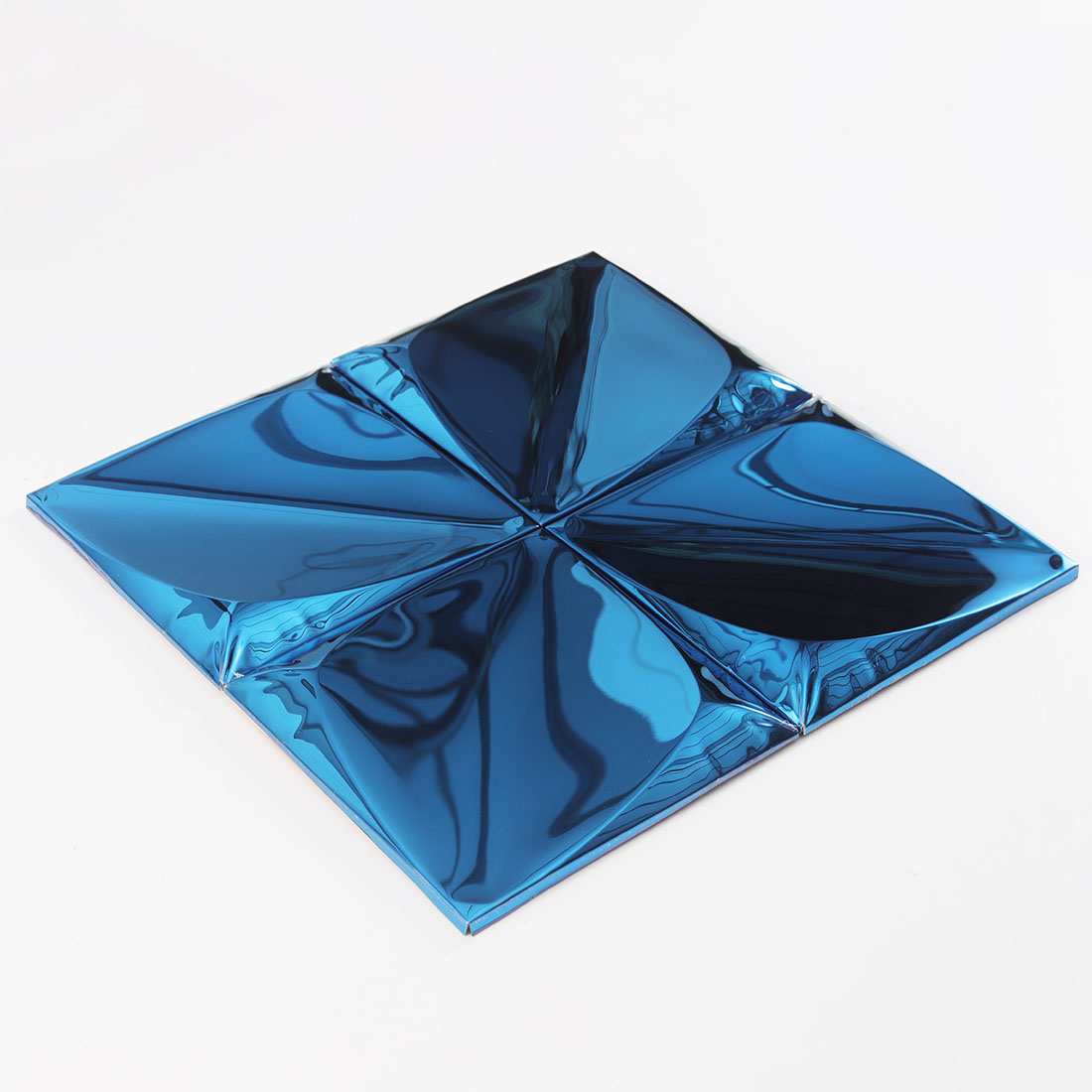 Blue raised pyramid metal mosaic tile shown from an angled side view
