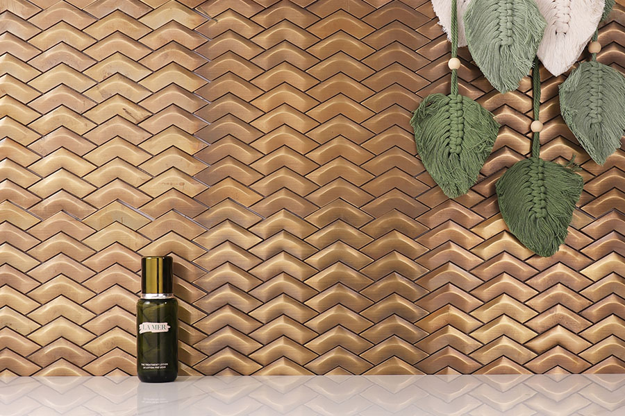 Antique brass chevron mosaic tile wall with warm metallic finish