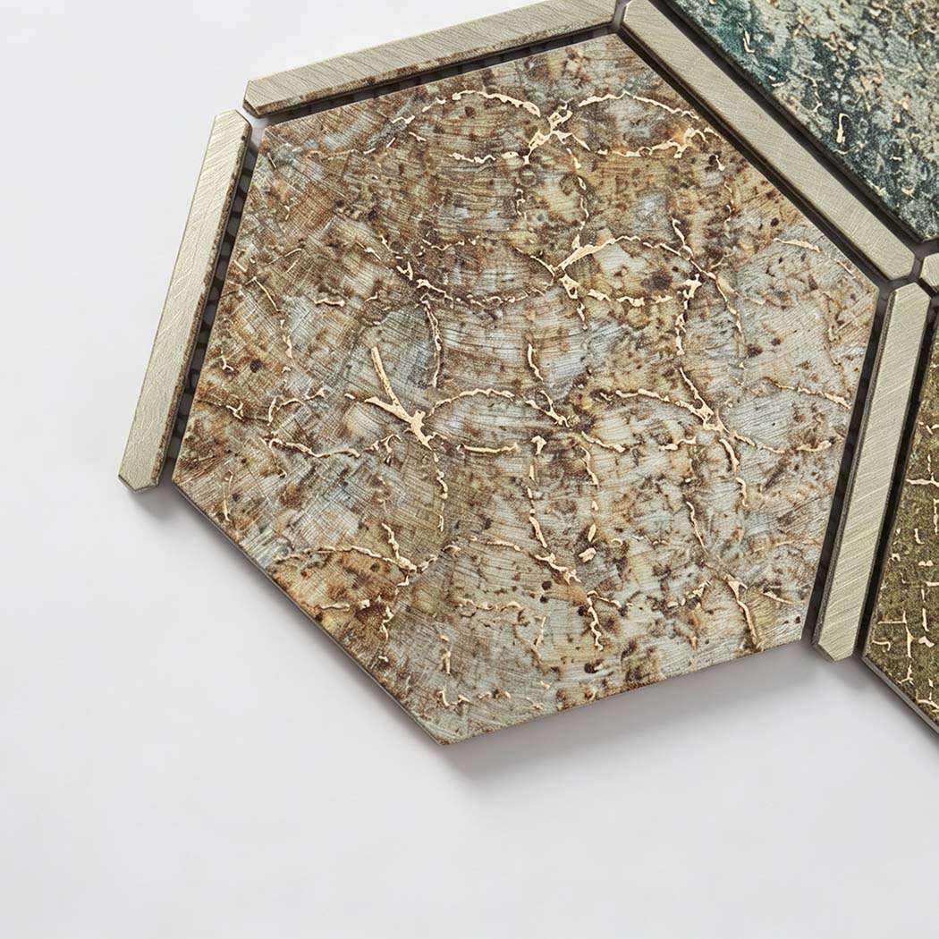 Close-up of a brown aluminum hexagon mosaic tile with brushed metal trim