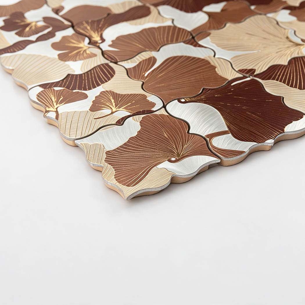 Angled close-up of brown floral aluminum mosaic tile with engraved petal texture