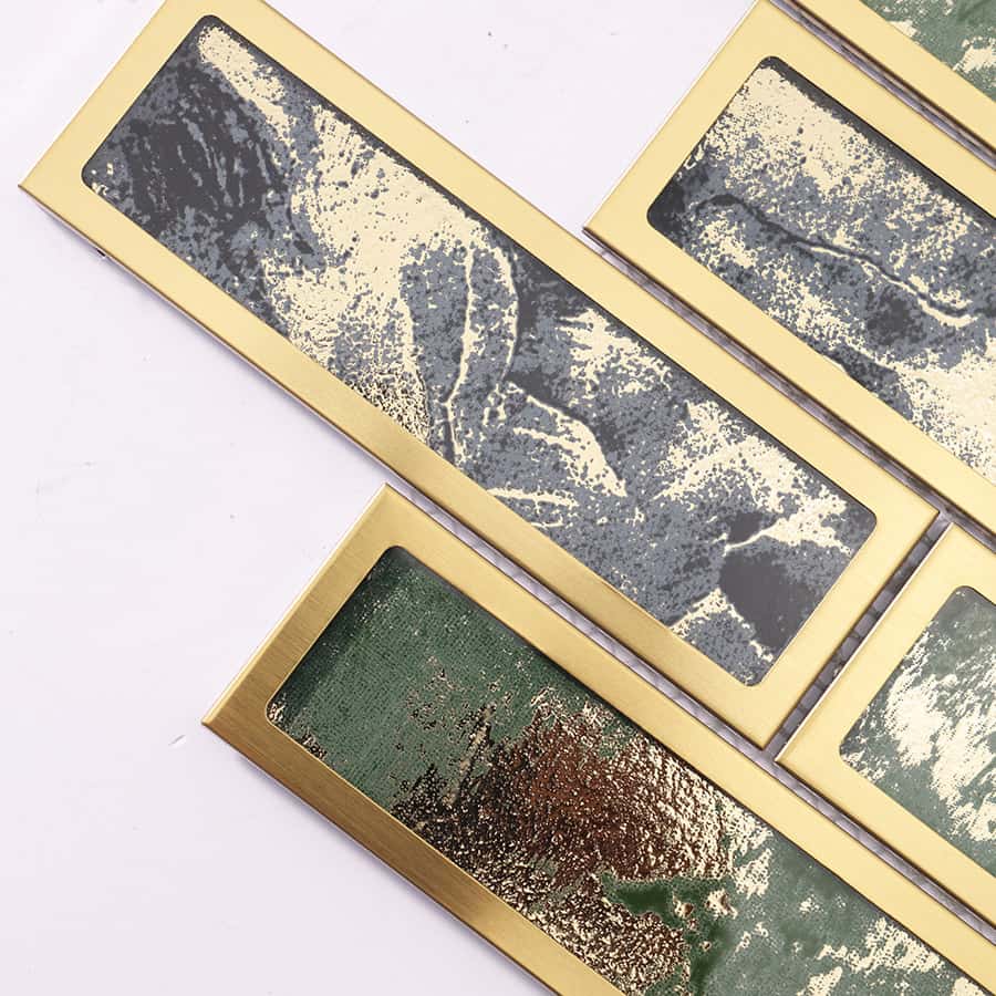 Mosaic tile pieces featuring green and black foil glass in brushed gold steel frames.