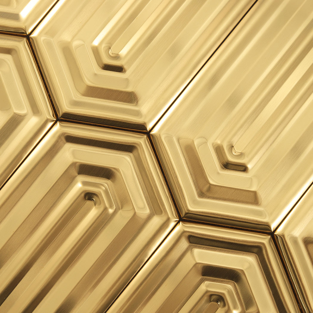 Macro view of brushed gold hexagon metal mosaic tile showing geometric layering and brushed finish