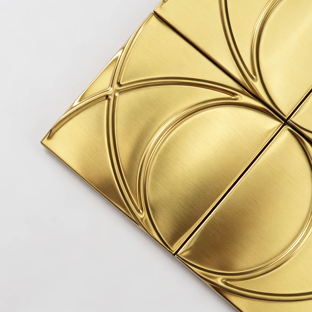 Corner close-up of brushed gold stainless steel square pattern mosaic tile