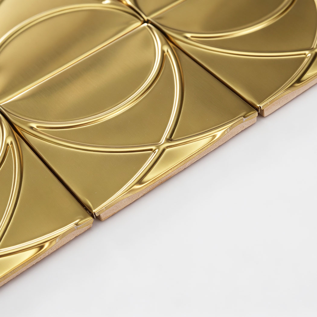 Edge detail of brushed gold stainless steel square pattern mosaic tile