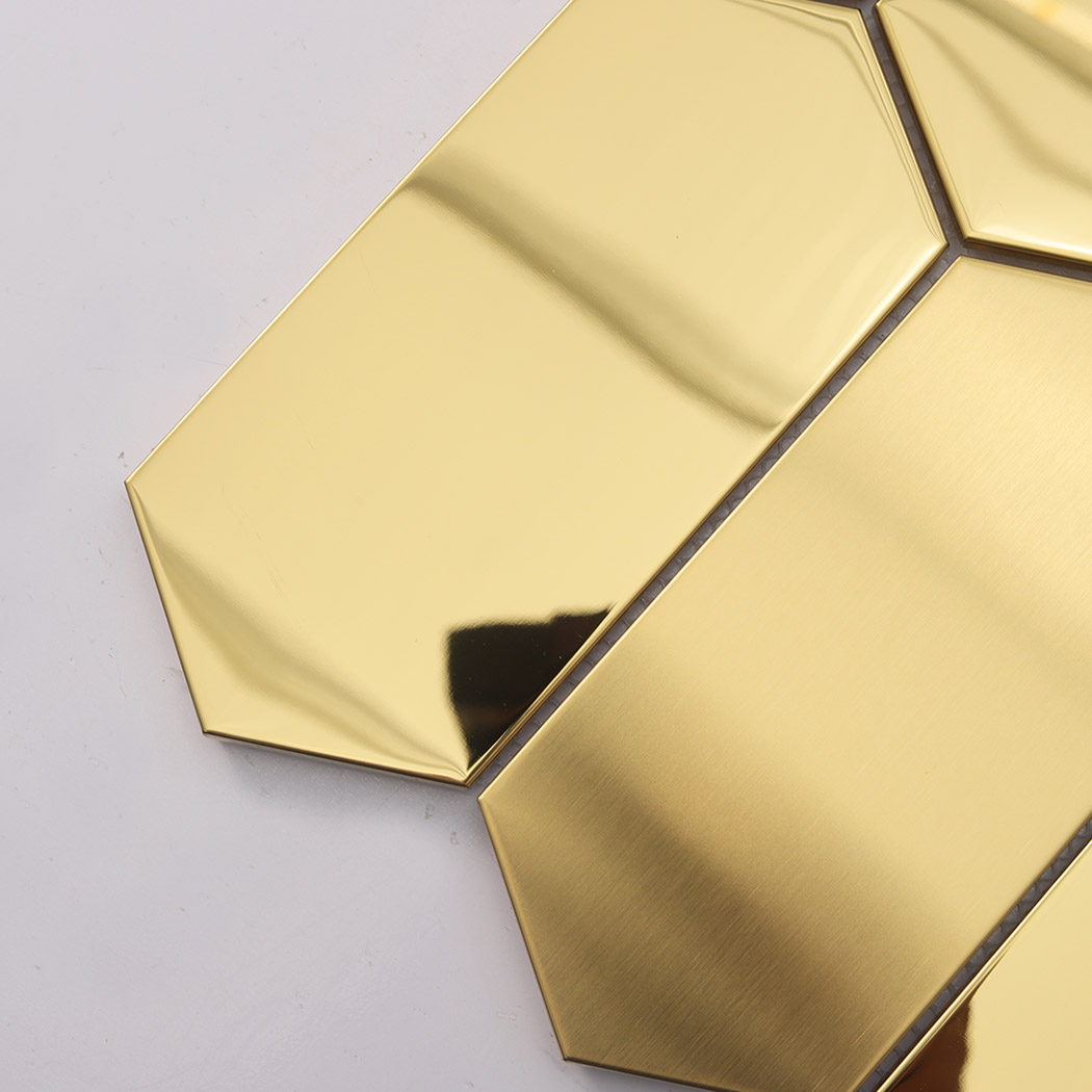 Close up of gold hexagon mosaic tile showing brushed and mirror texture detail