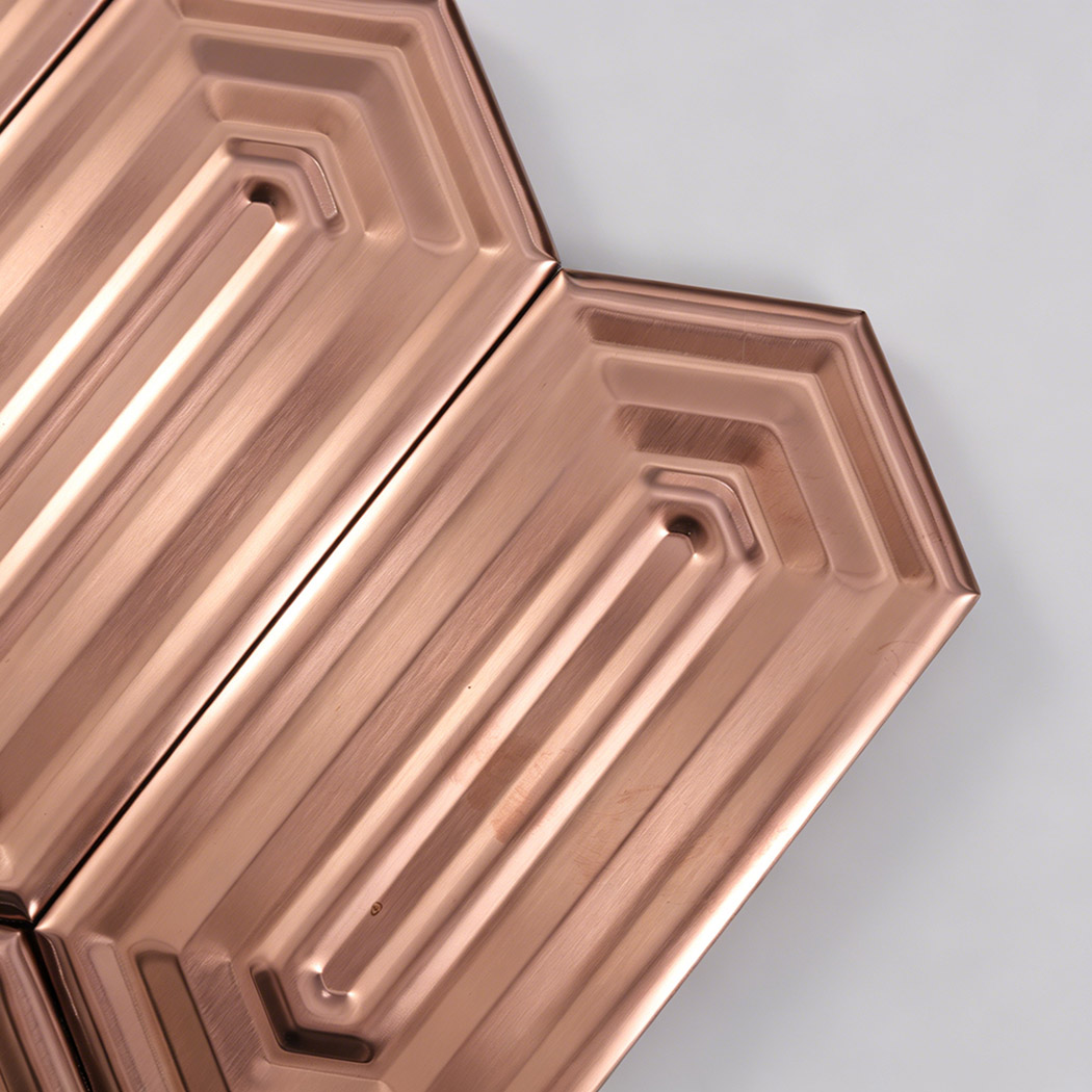 Close up brushed rose gold hexagon metal mosaic showing brushed metallic texture