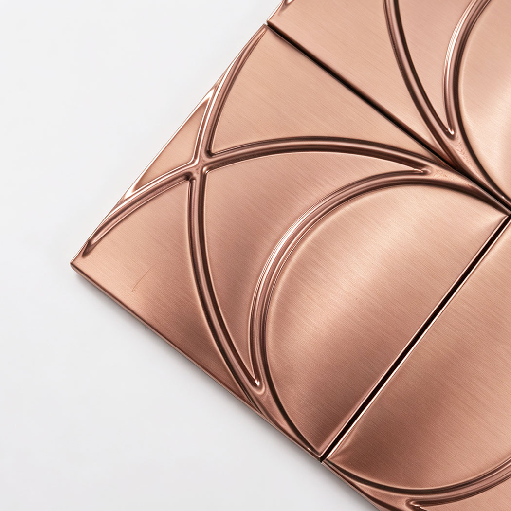 Corner close-up of brushed rose gold stainless steel square pattern mosaic tile